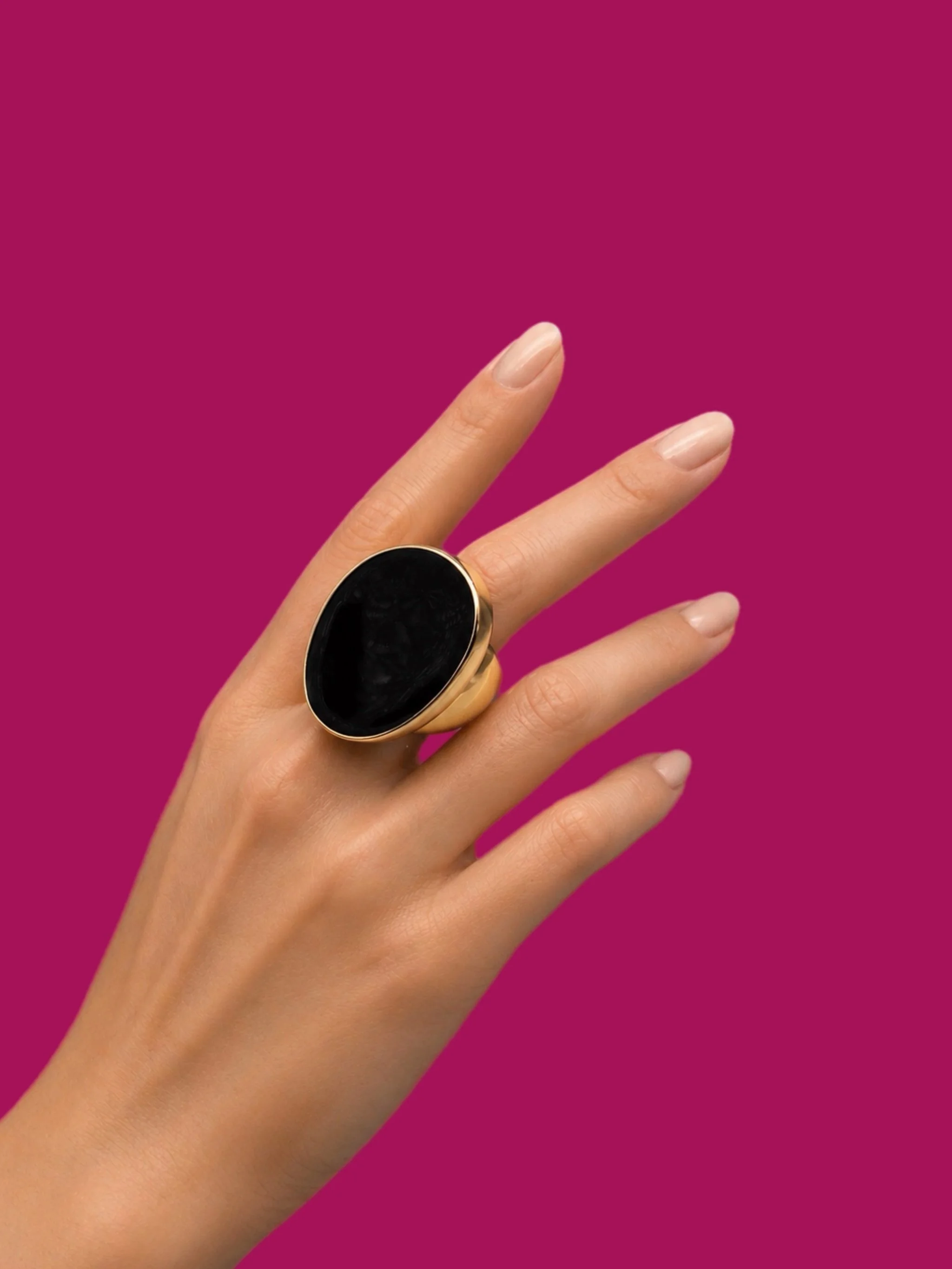 Kenneth Jay Lane gold-tone ring with black enamel oval top, bold statement ring, worn on hand — Crepundia Gioielli Bologna