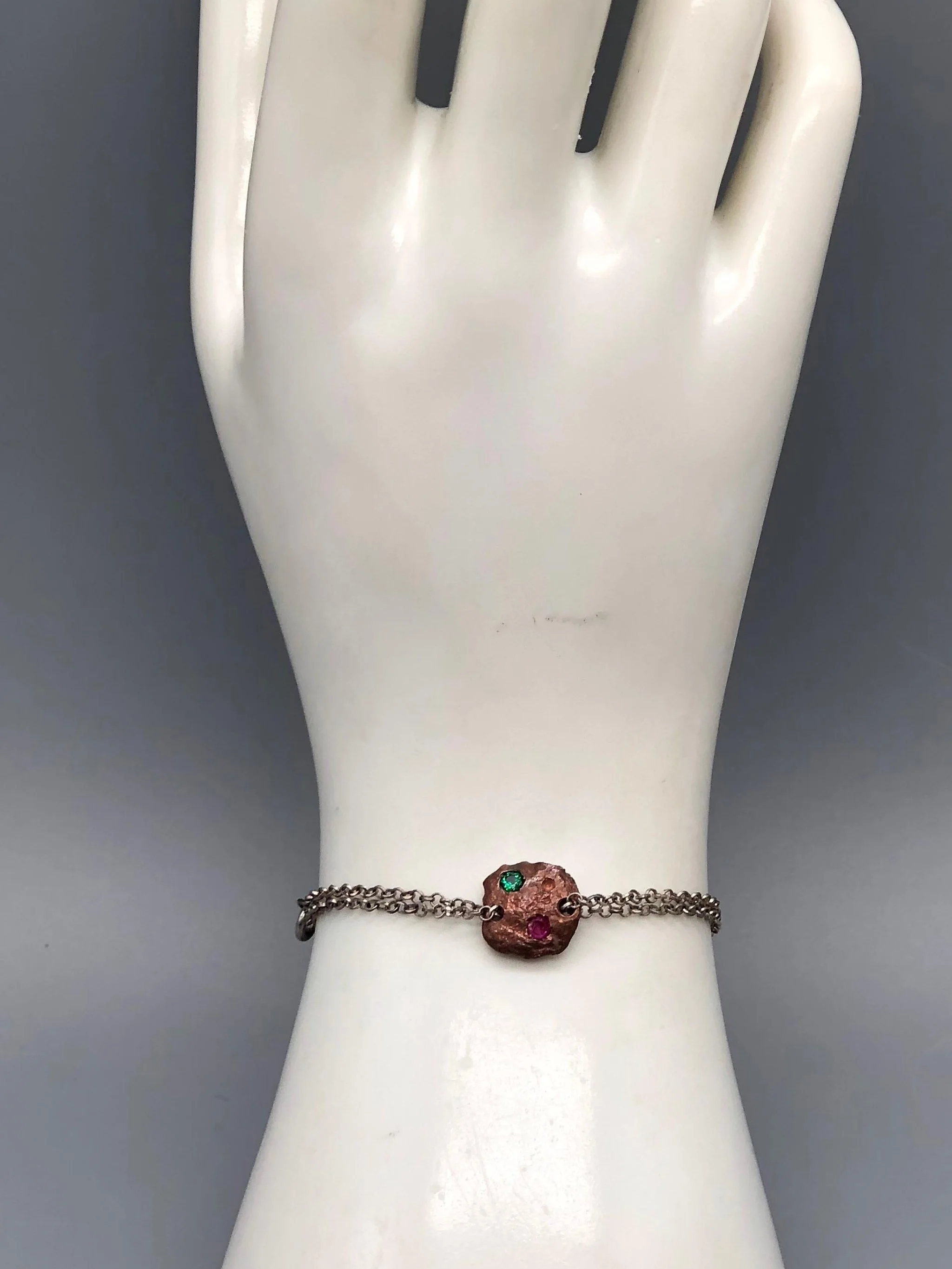 Crepundia Tracce bracelet in silver with irregular bronze element and two coloured stones.