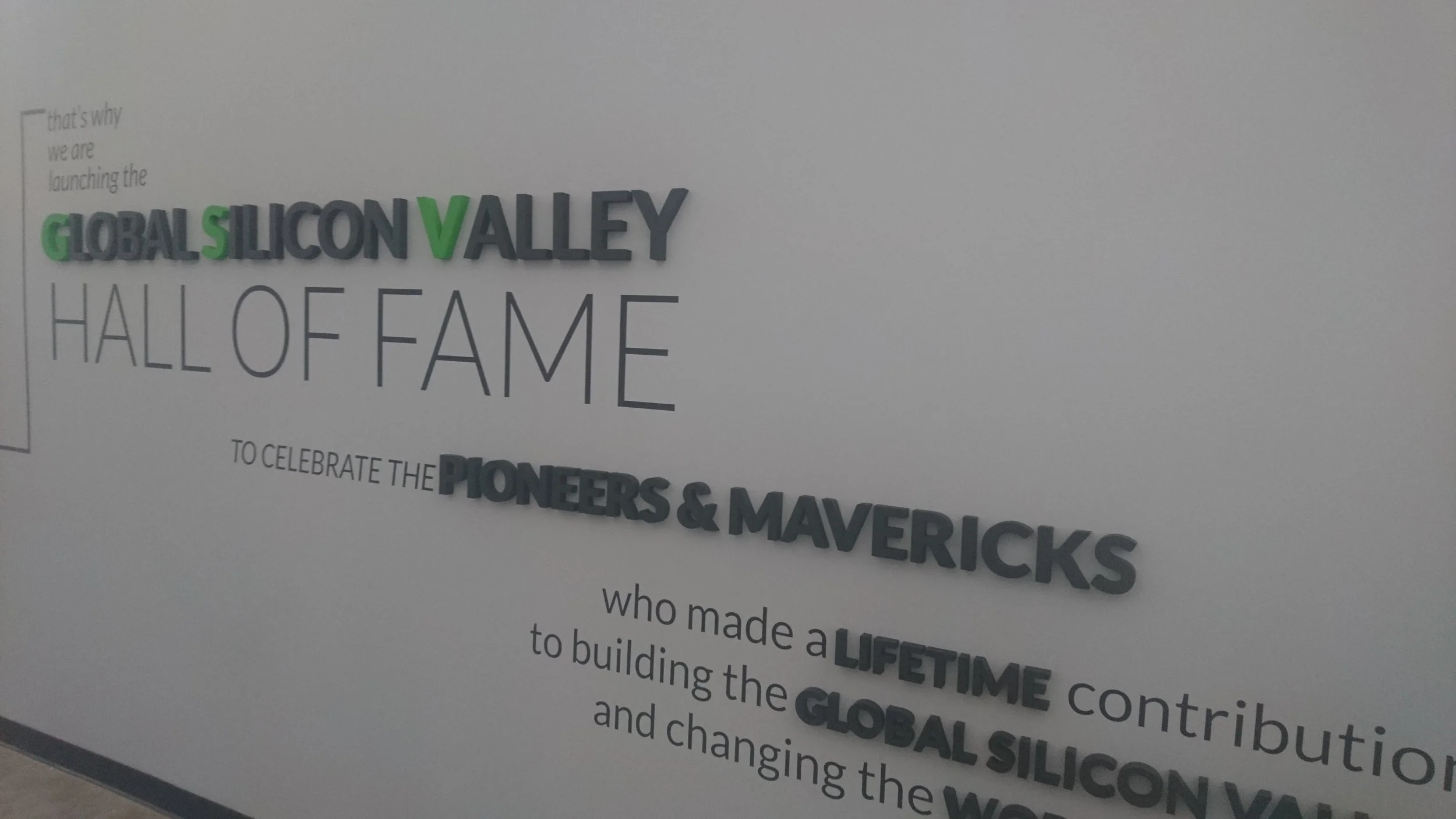 A wall display celebrating the inductees into the Silicon Valley Hall of Fame, featuring the words "Global Silicon Valley Hall of Fame" and names of pioneers and mavericks.