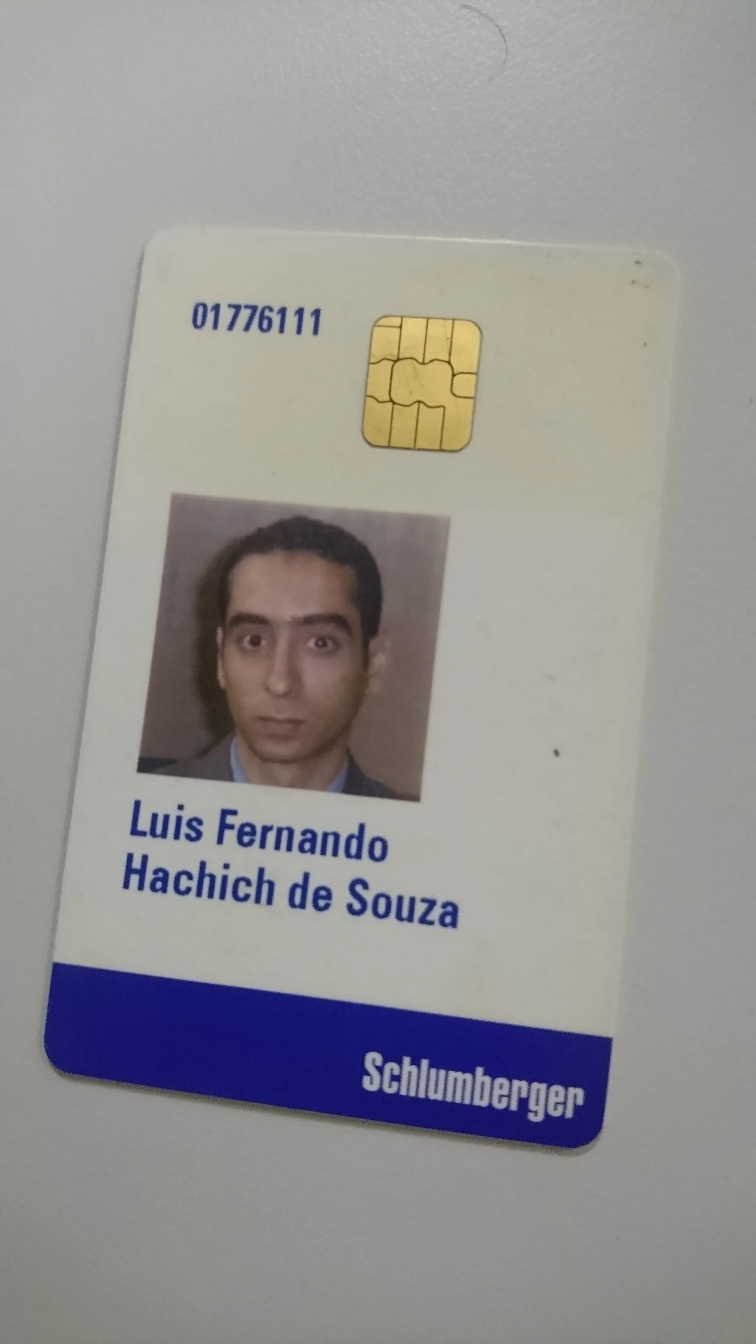 Identification badge with a photo of a young man, name Luis Fernando Hachich de Souza, and the company name Schlumberger.