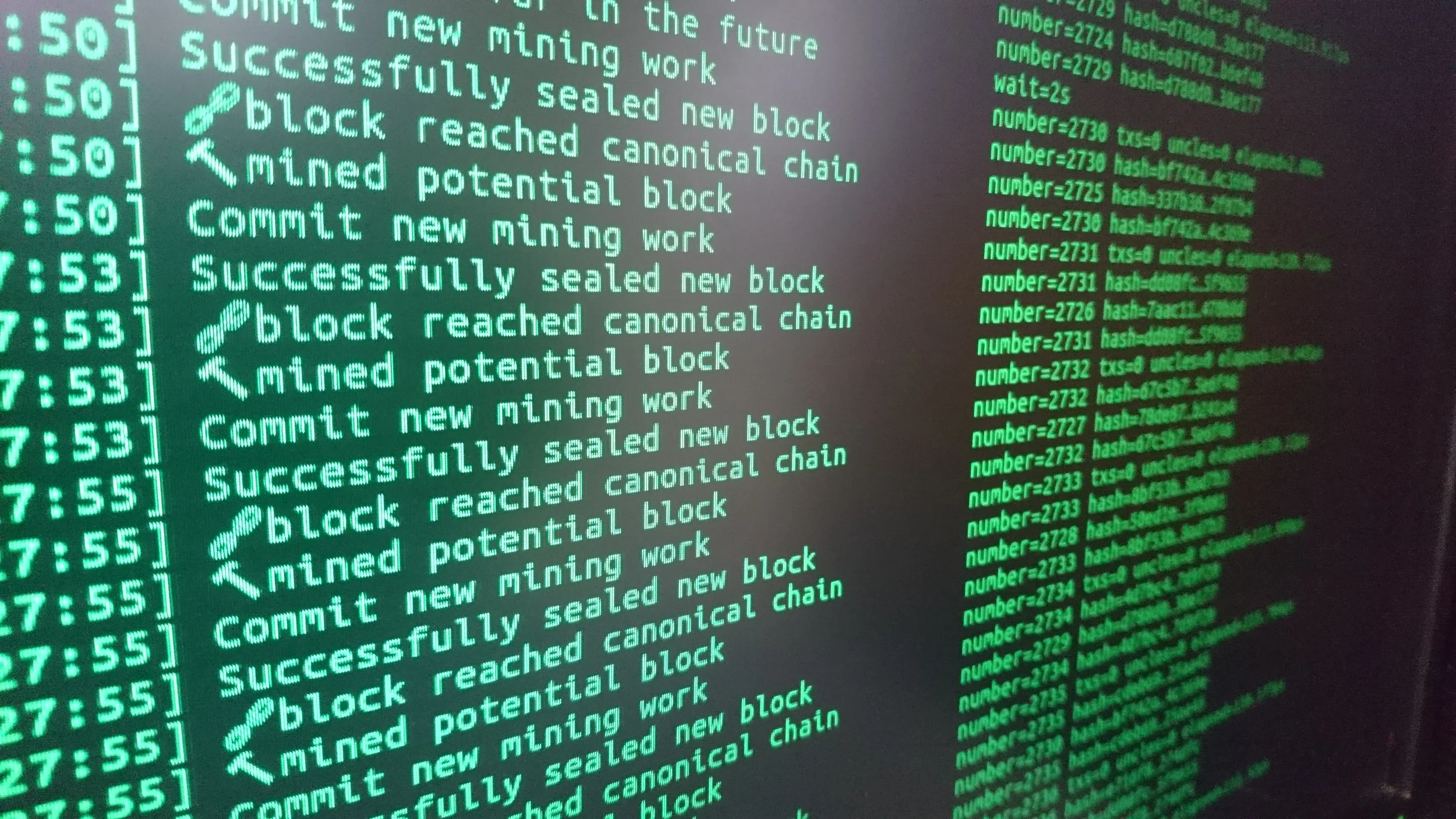 A computer screen displaying a blockchain mining operation with status logs in green text, showing blocks being reached, mined, and sealed.