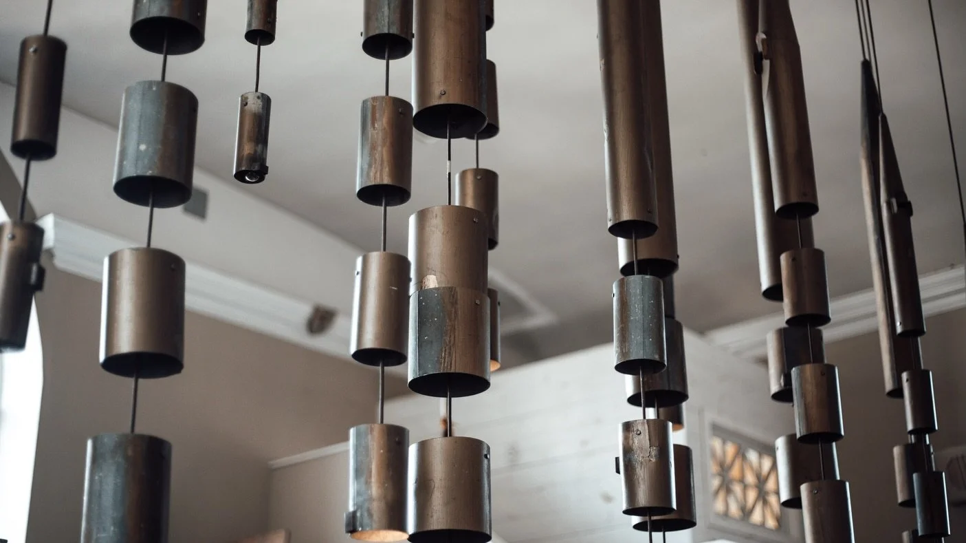 A piece of history restored. The organ pipes that were destined for the dump were carefully repurposed into light sculptures installed throughout our building. The most iconic generously illuminates the main dining room, transforming the environment 
