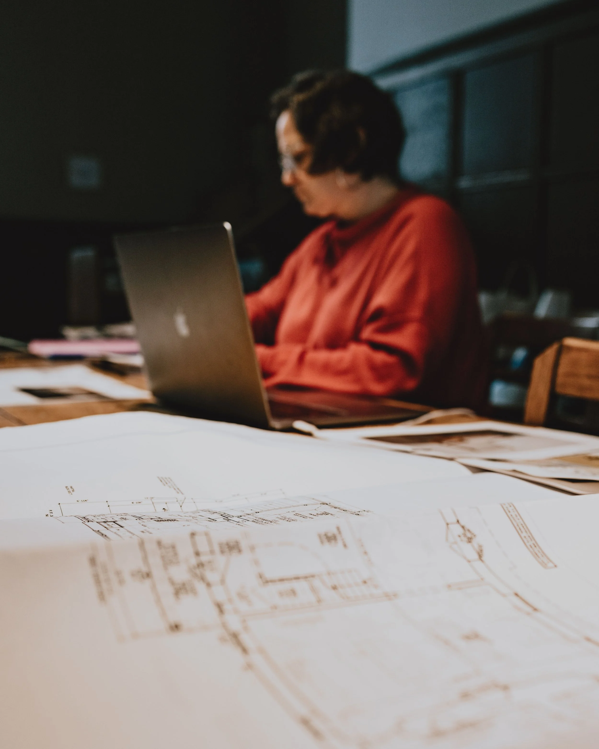 Person working in a shared space in East Falls on architectural drawings