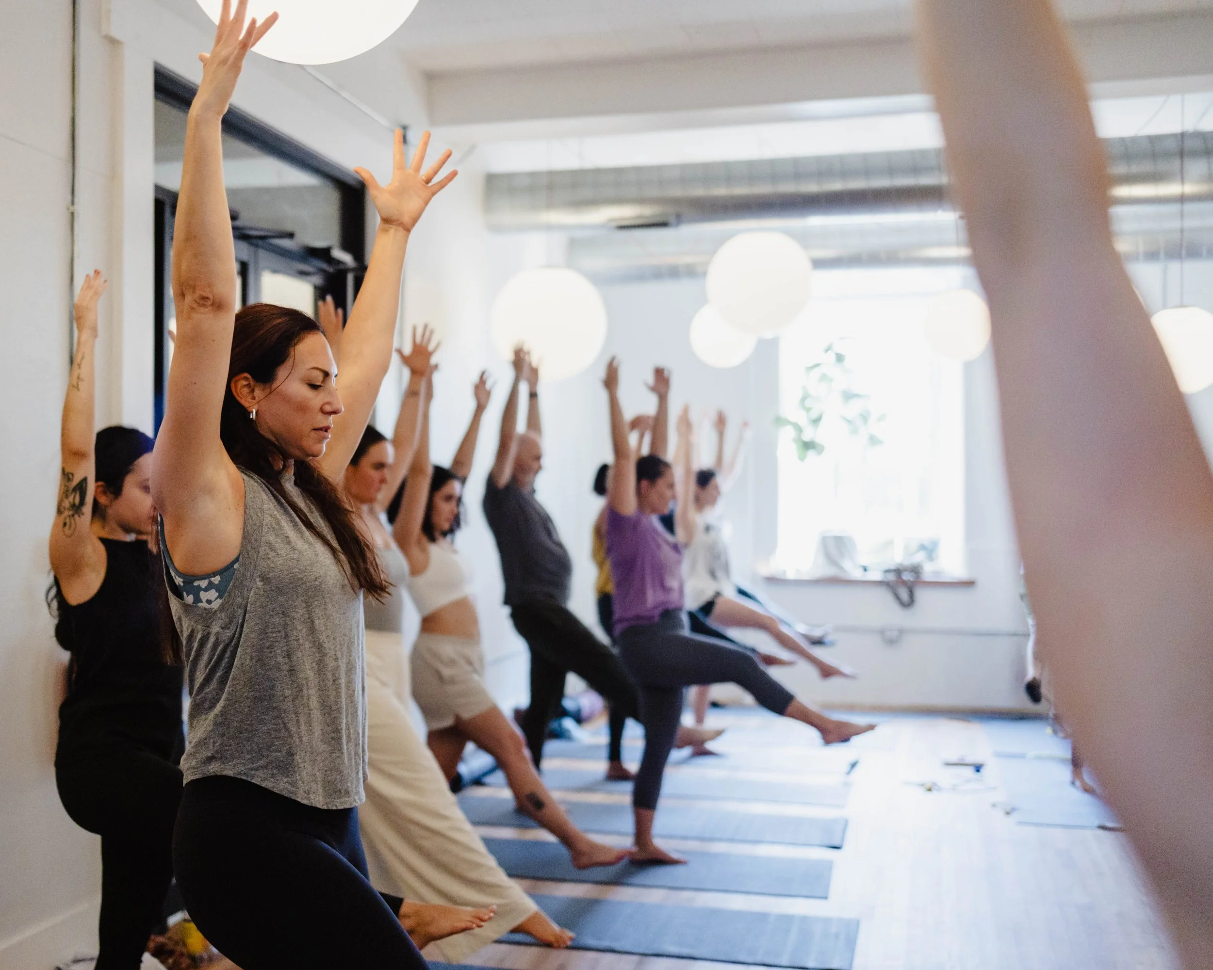 People taking a yoga class in a room with bubble lighting in East Falls