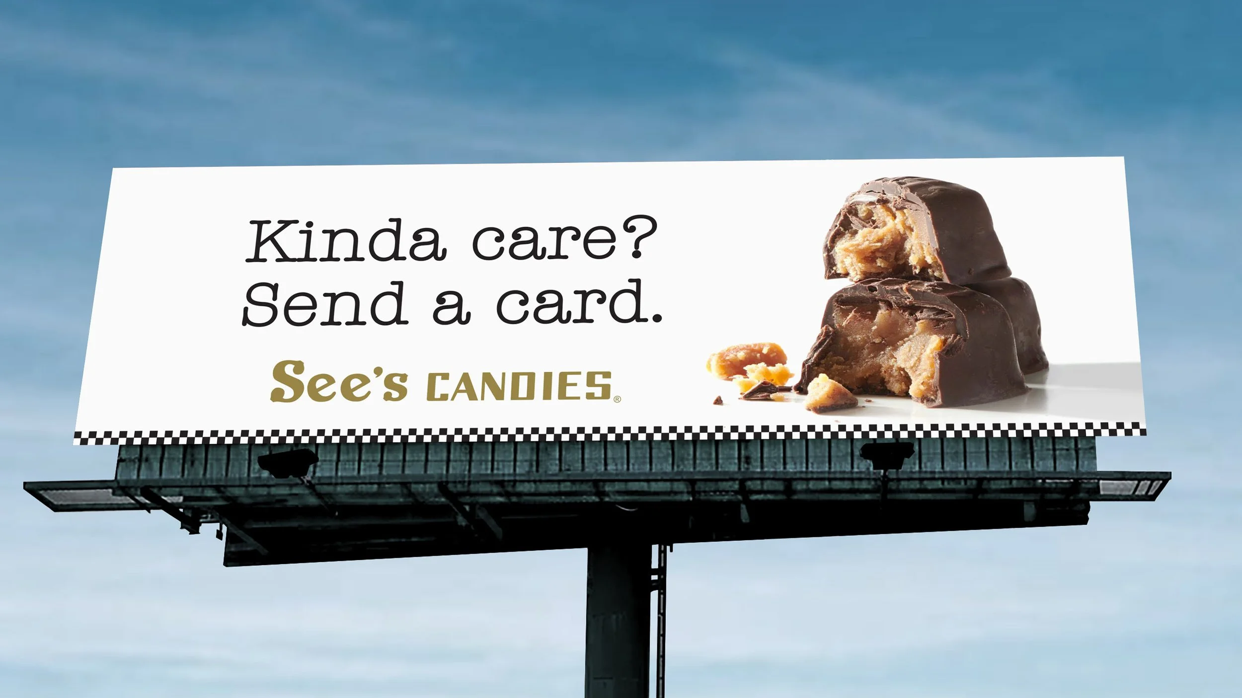 An outdoor billboard featuring pieces of chocolate See's Candies with a headline that reads, "Kina care? Send a card."