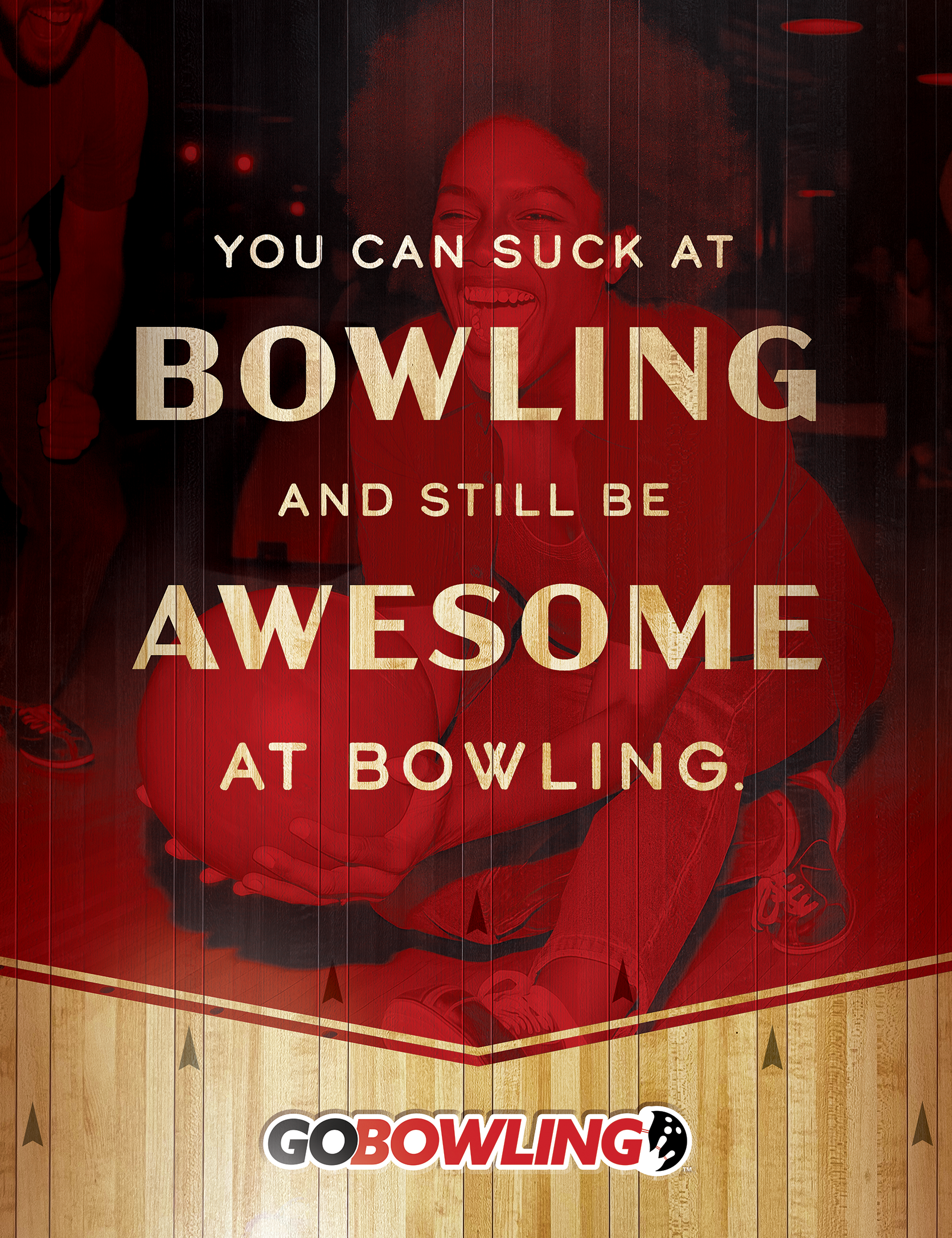 Photo of a print ad featuring a woman bowling and a headline that reads, "You can suck at bowling and still be awesome at bowling." The Go Bowling logo is at the bottom of the ad.