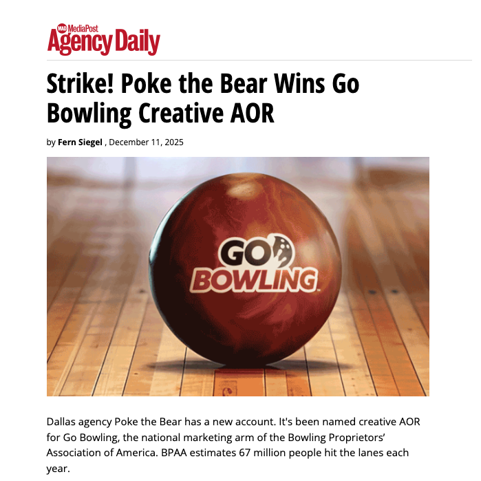 A brown bowling ball with the logo 'GO BOWLING' placed on a wooden bowling lane.