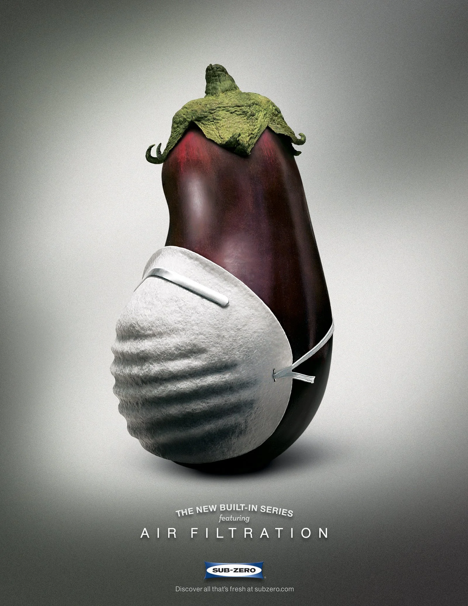 Sub-Zero refrigerator print ad featuring a photo of an eggplant wearing a dust mask and a headline that reads, "The new built-in series featuring Air Filtration."