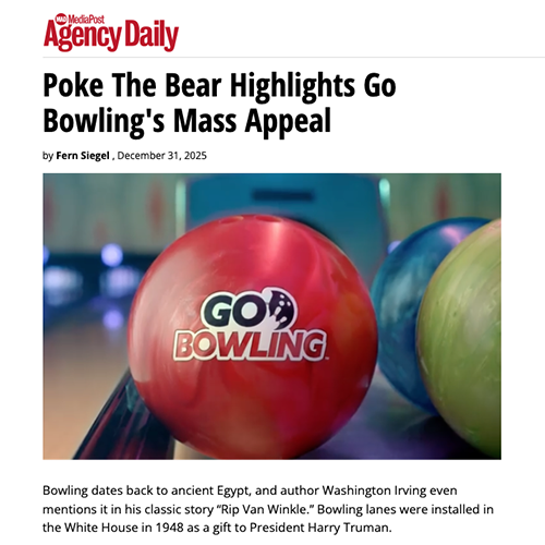 Close-up of colorful bowling balls at a bowling alley, with a red ball in focus featuring the logo 'Go Bowling'.