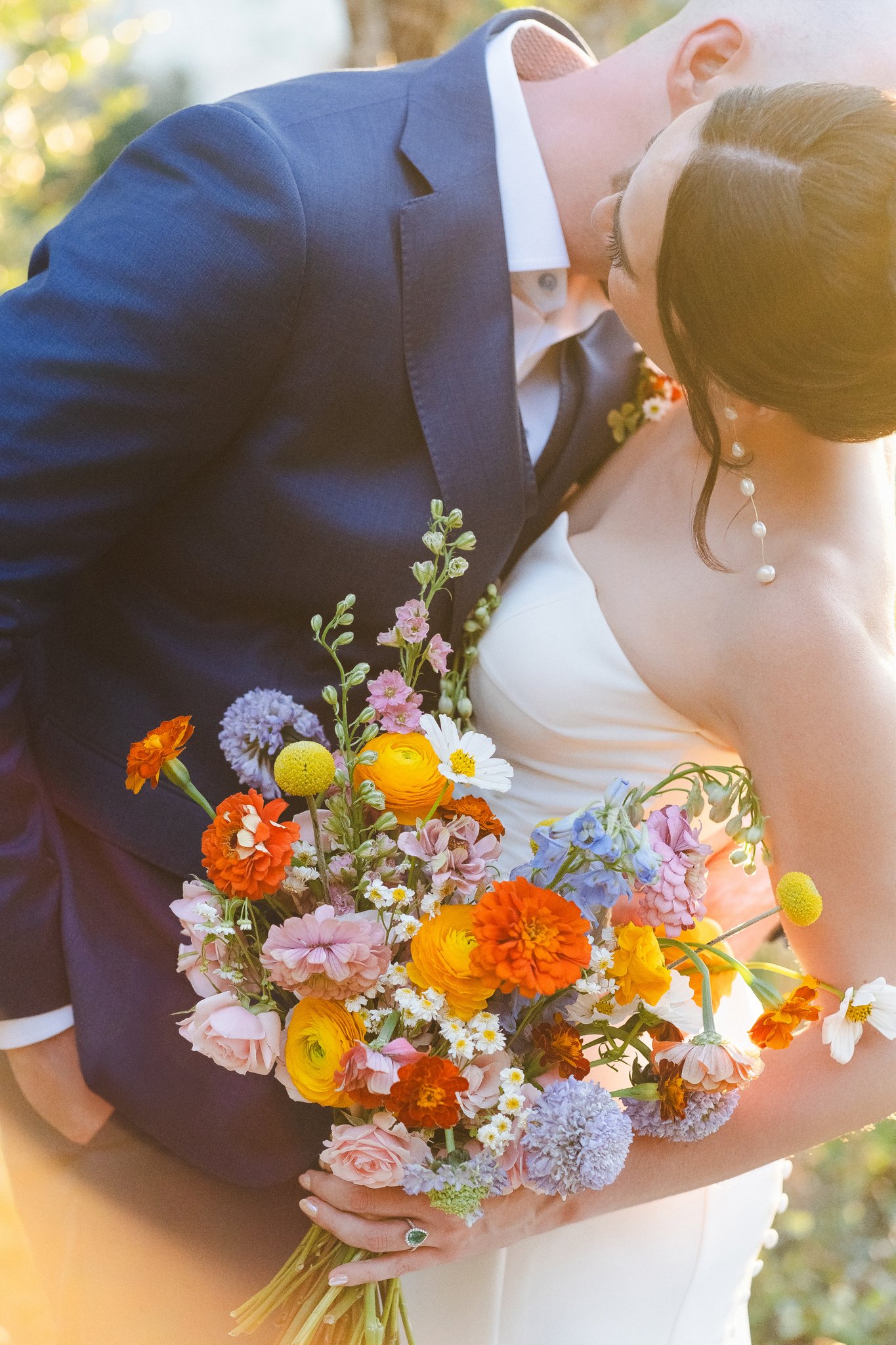 Unique Floral Shot at LBJ Wildflower Center, picture of Bride and Groom during golden hour shot by Photos by Mkay Wedding Photography