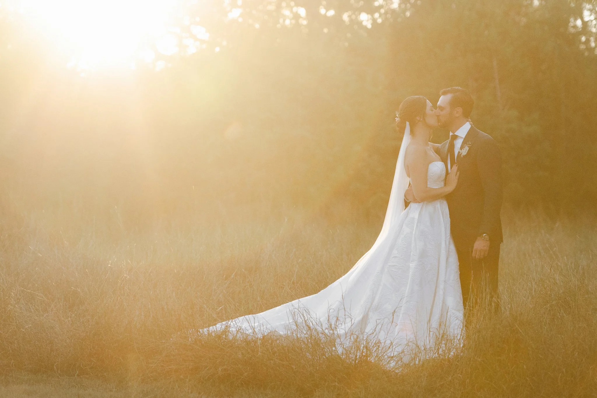 Golden Hour Glow of a Bride and Groom in a Texas Field Shot at The Addison Grove Wedding Venue by Photos by Mkay Wedding photography