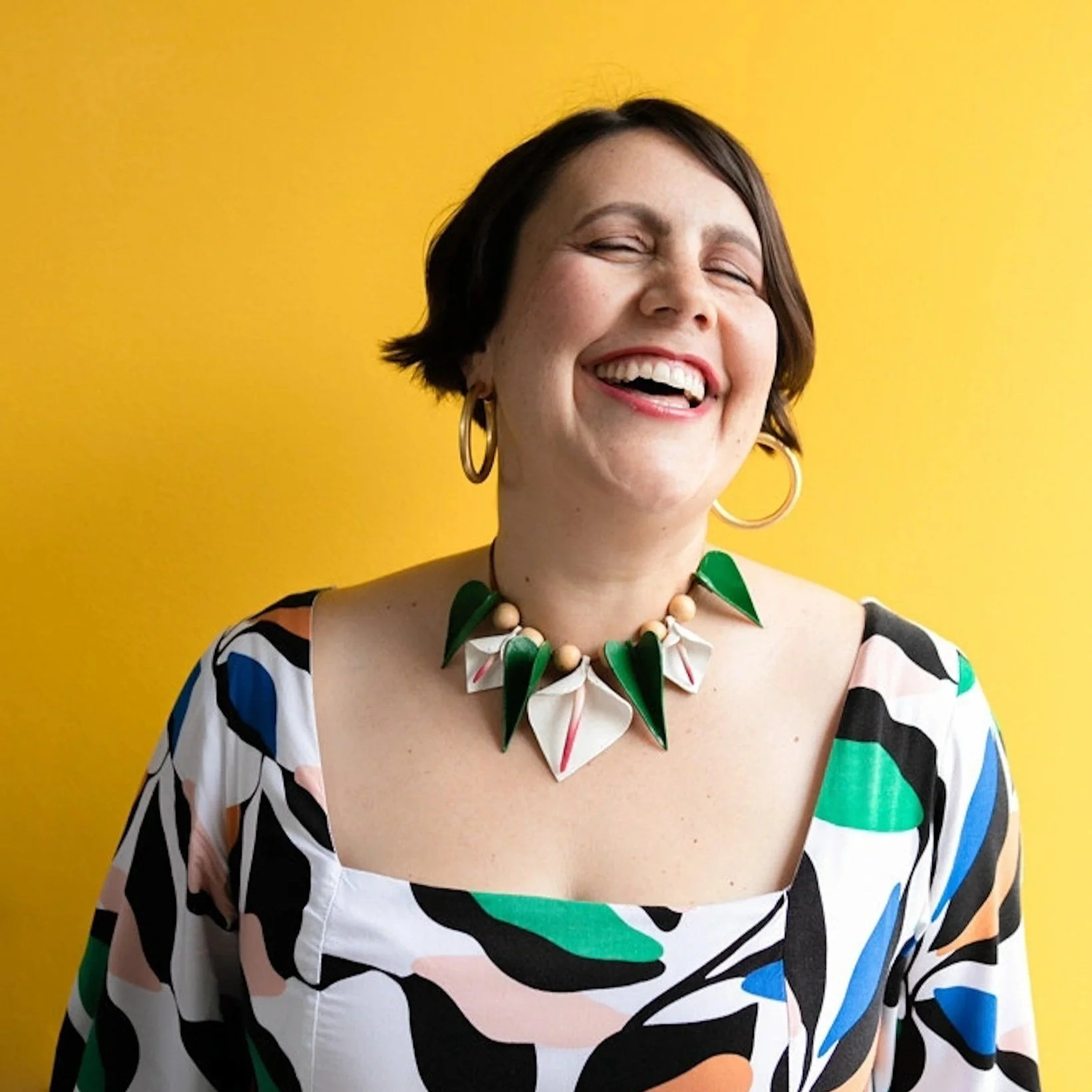 colorful headshot of woman laughing