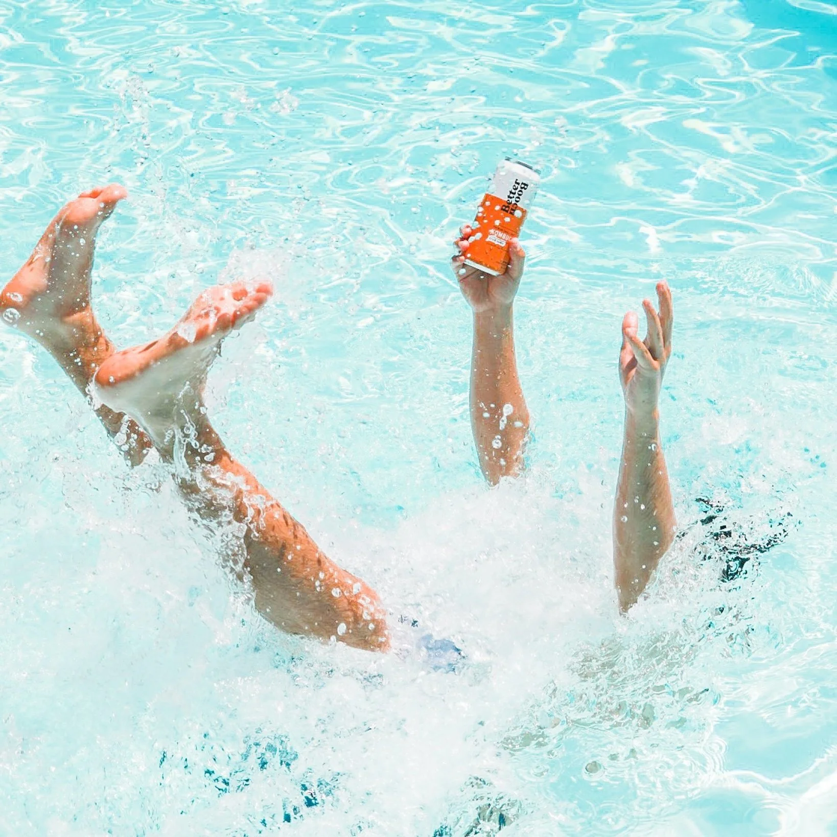 kombucha drink beverage product photo falling into pool holding a can