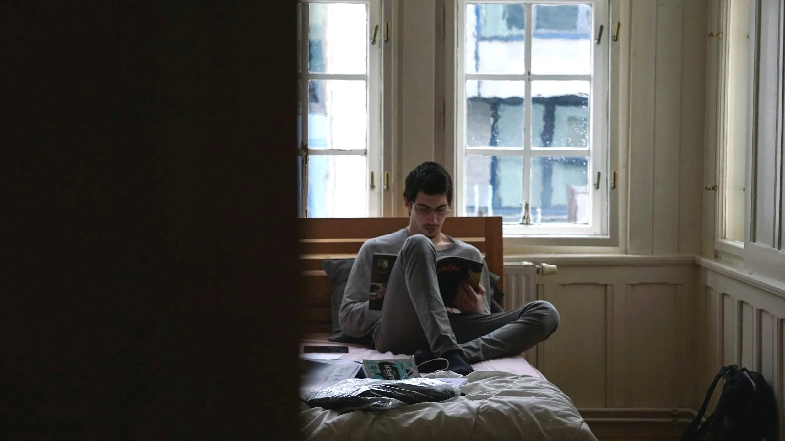 A teenager's bedroom door slightly ajar with hallway light spilling in