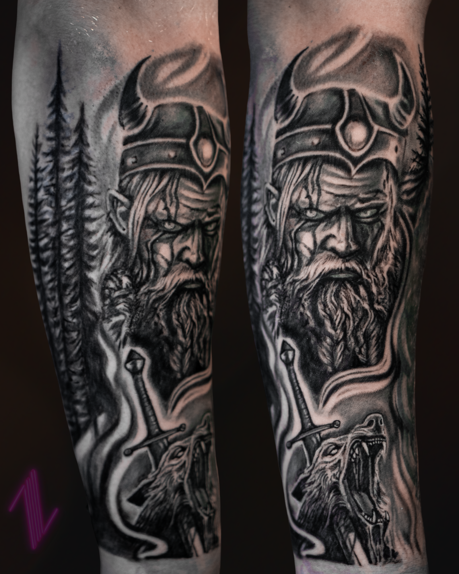 Black and gray tattoo of a Viking warrior with a beard and helmet, tall pine trees in the background, a sword piercing a snarling wolf, and smoke or mist swirling around.