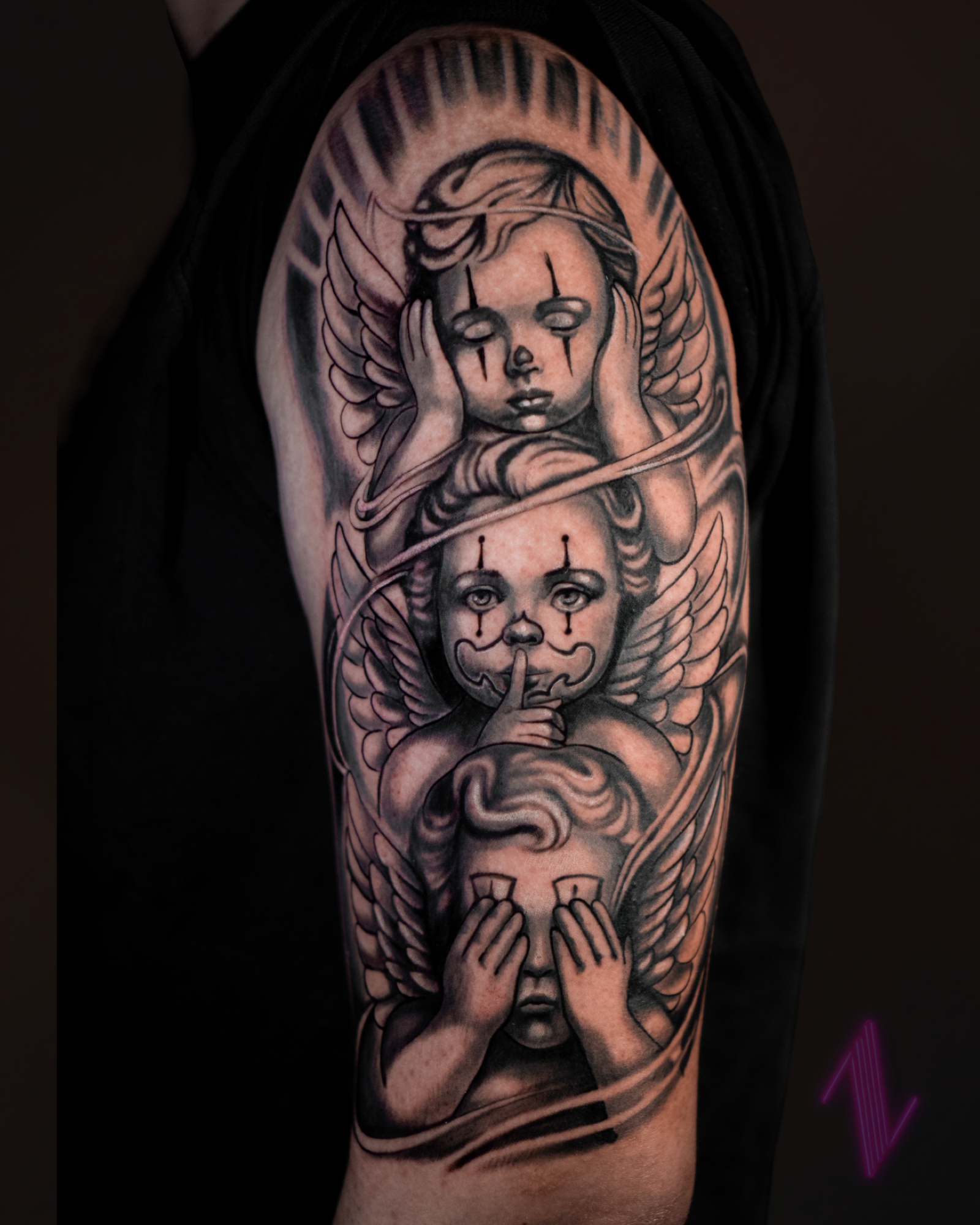 Tattoo of three winged children with tears, with the bottom child covering eyes.