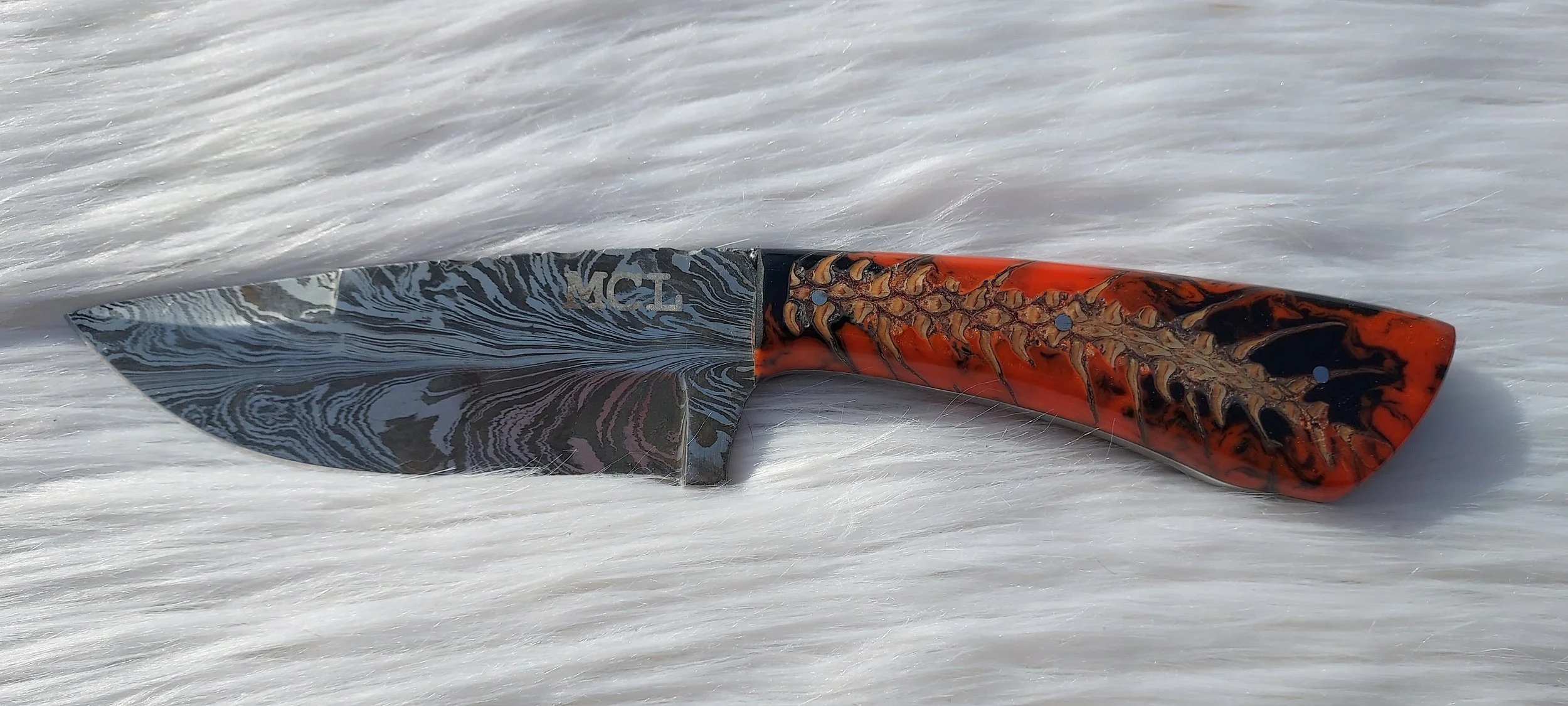 feather Damascus with a pinecone in orange resin