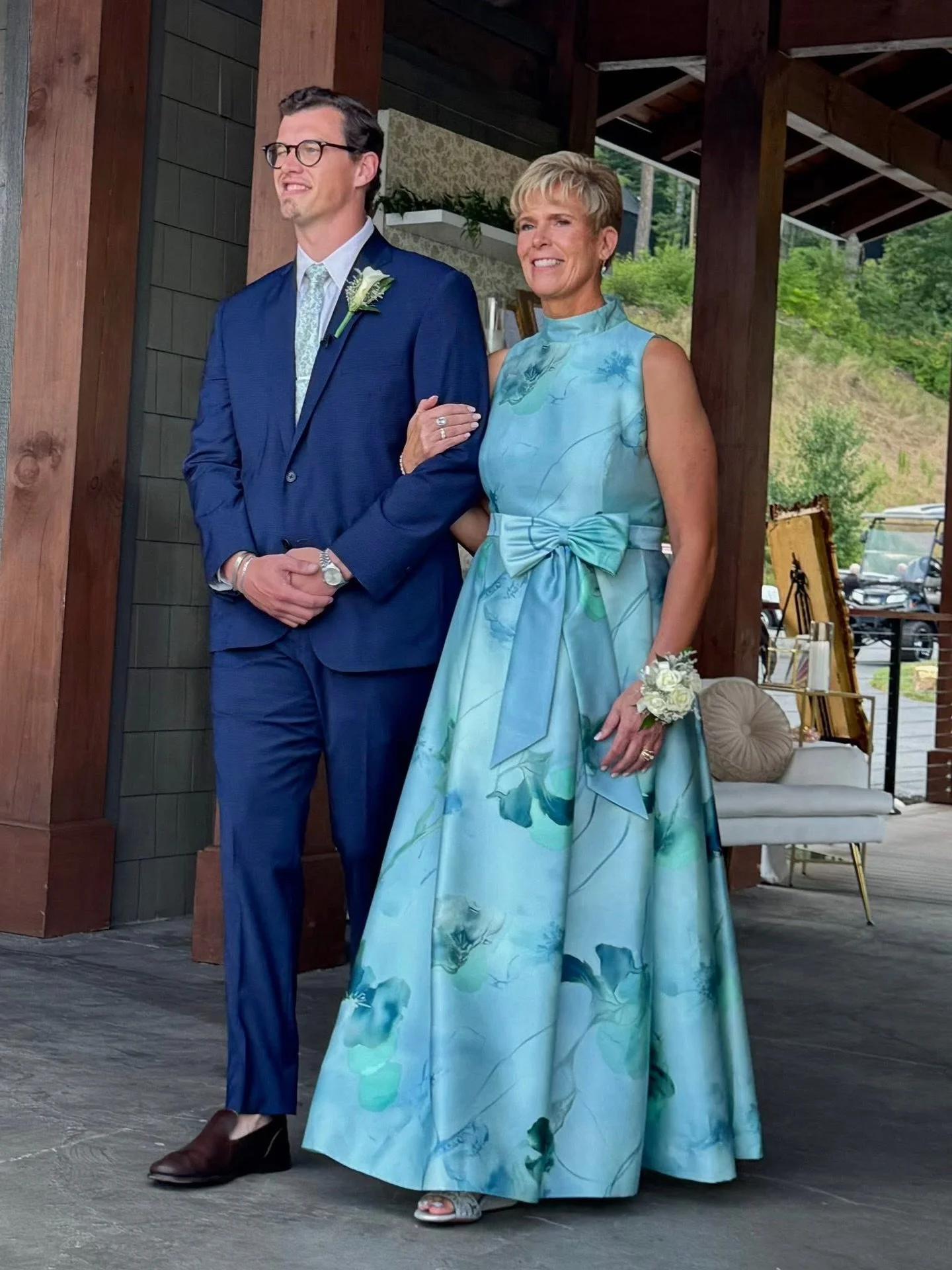 In Garden Serenade we watch elegance unfold with every step. Our client glows in this glazed-blue column silhouette &mdash; a quiet symphony of refined structure and painterly florals that feels like a watercolor garden at dawn. Graceful, poised, and