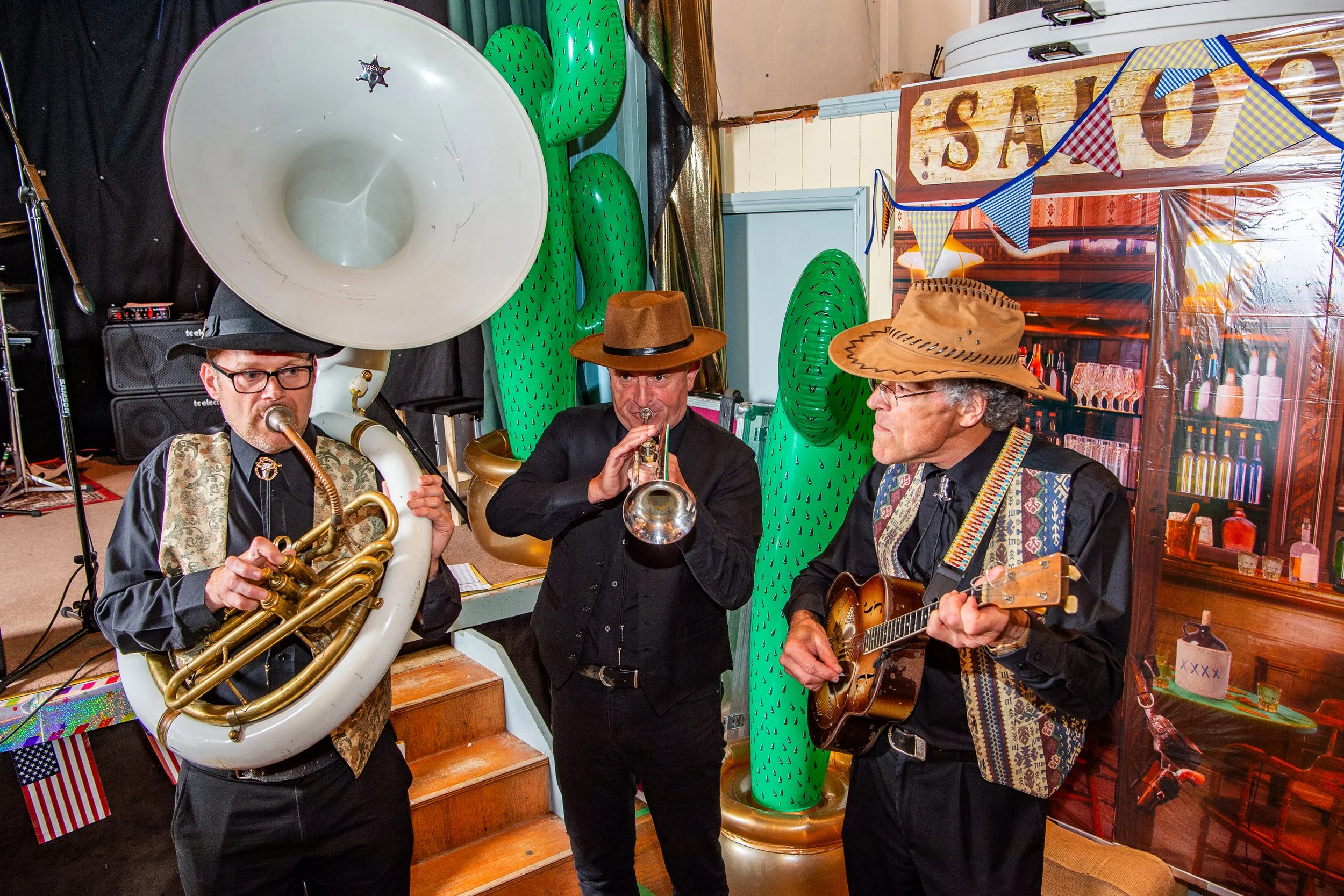 Roaming acoustic Jazz band performing in cowboy outfits at a themed private anniversary party