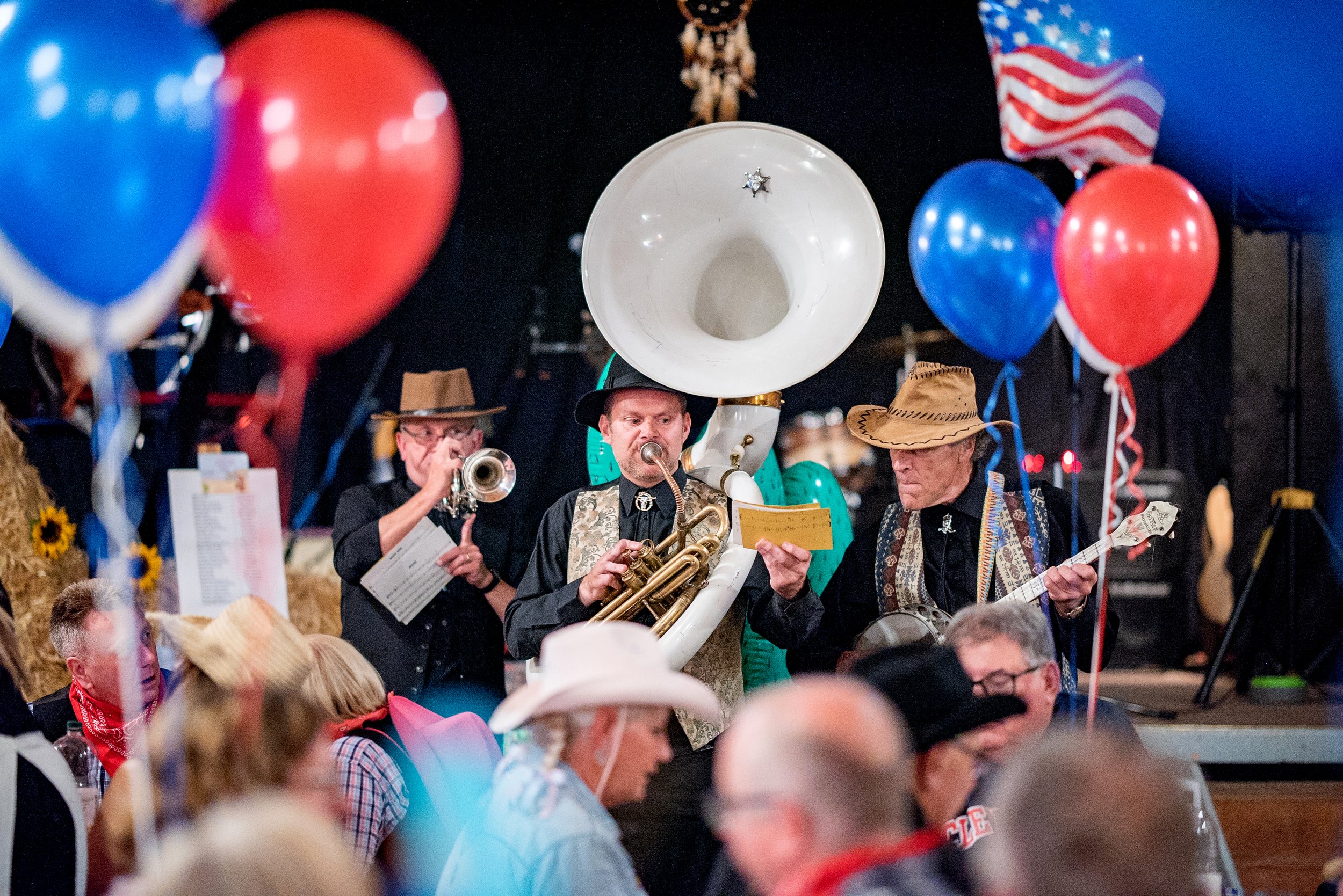 Roaming acoustic Jazz band performing in cowboy outfits at a themed private anniversary party