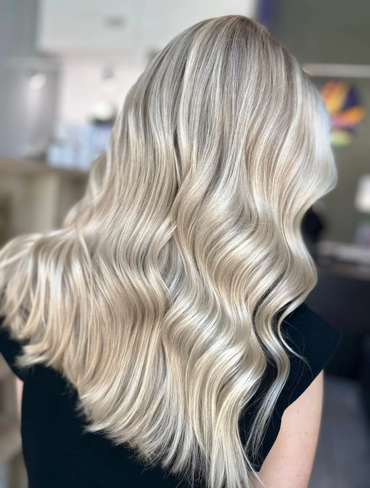 Hair with platinum blonde color styled in loose waves.