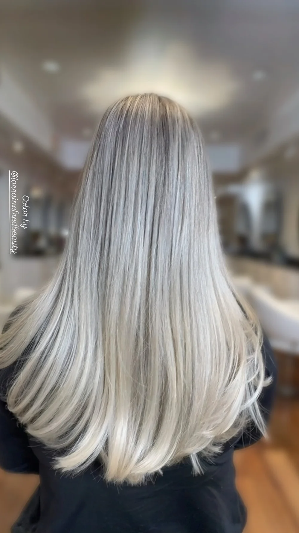 Long, bright platinum blonde hair after a blonding service by Lorraine Fred