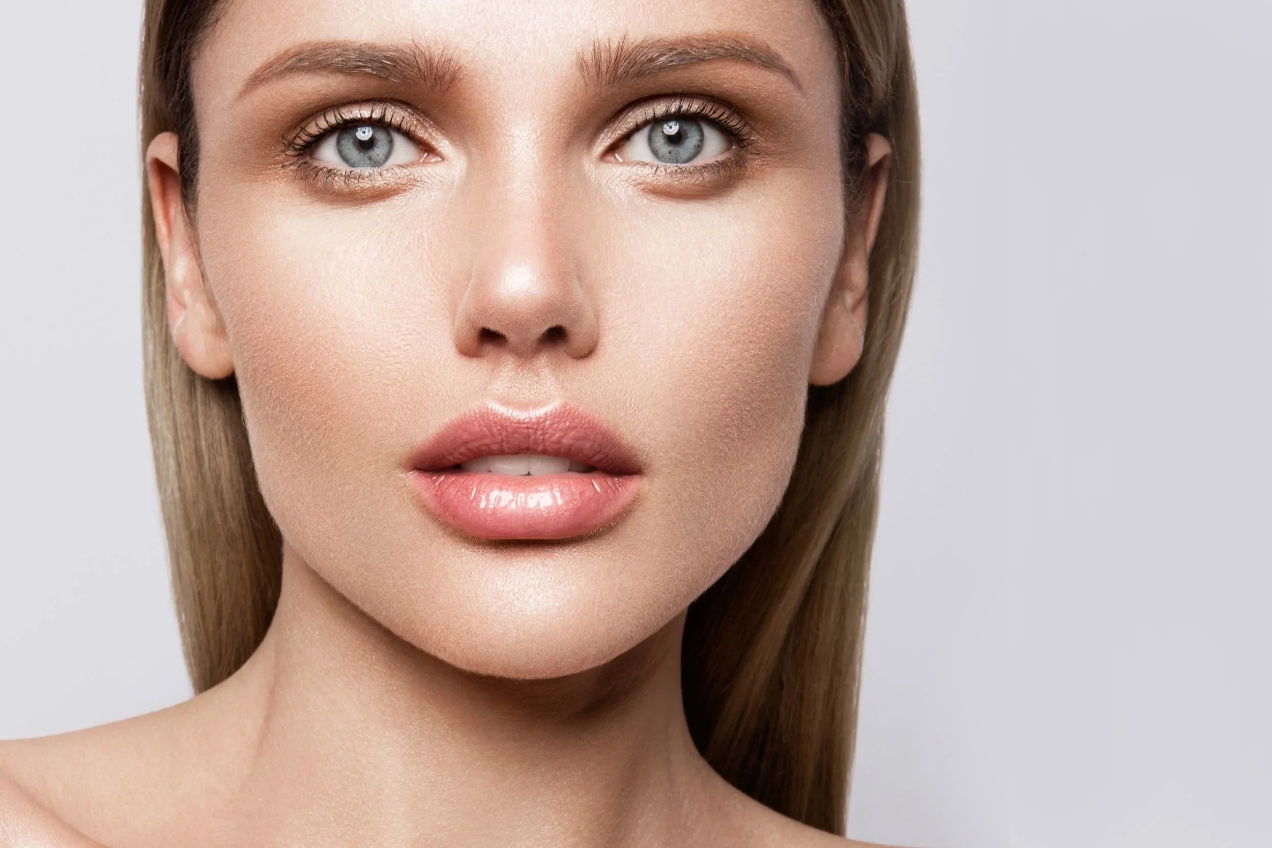 Close-up of a woman’s eye area highlighting eyelashes and brows, representing Latisse lash serum treatment for fuller-looking lashes.