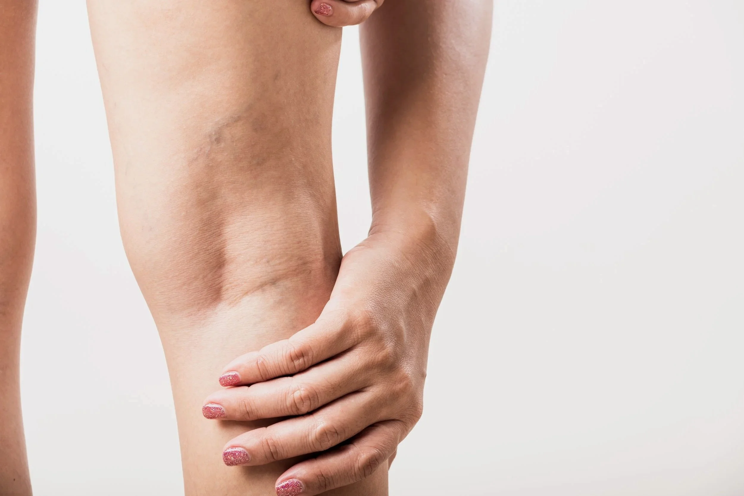 A person holding their knee, which appears to be injured or sore.