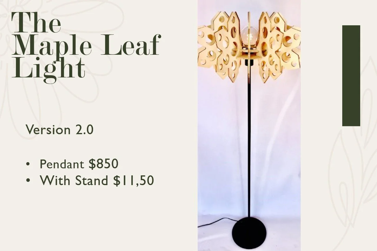 A decorative floor lamp with a wooden maple leaf design on the light fixture and a black round base.