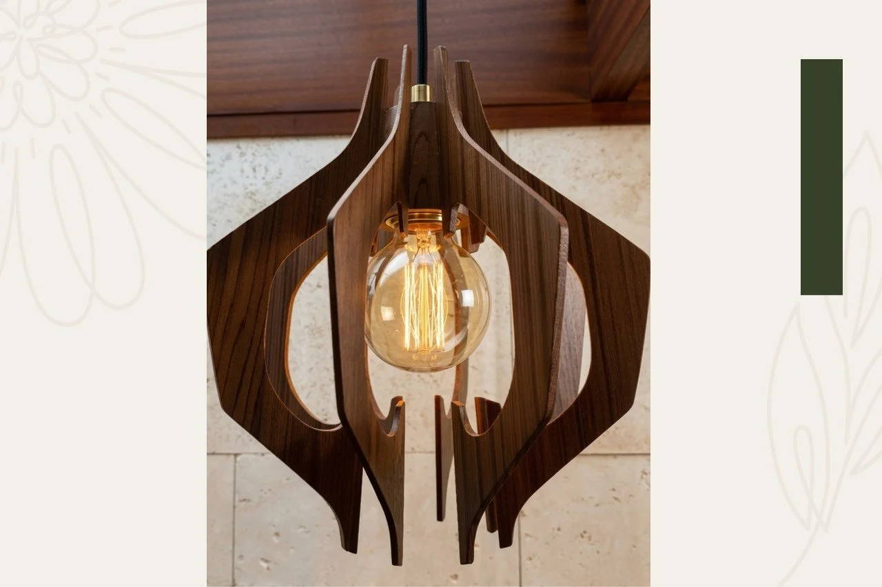 A modern wooden pendant light fixture with an Edison-style filament bulb hanging from a black cord.