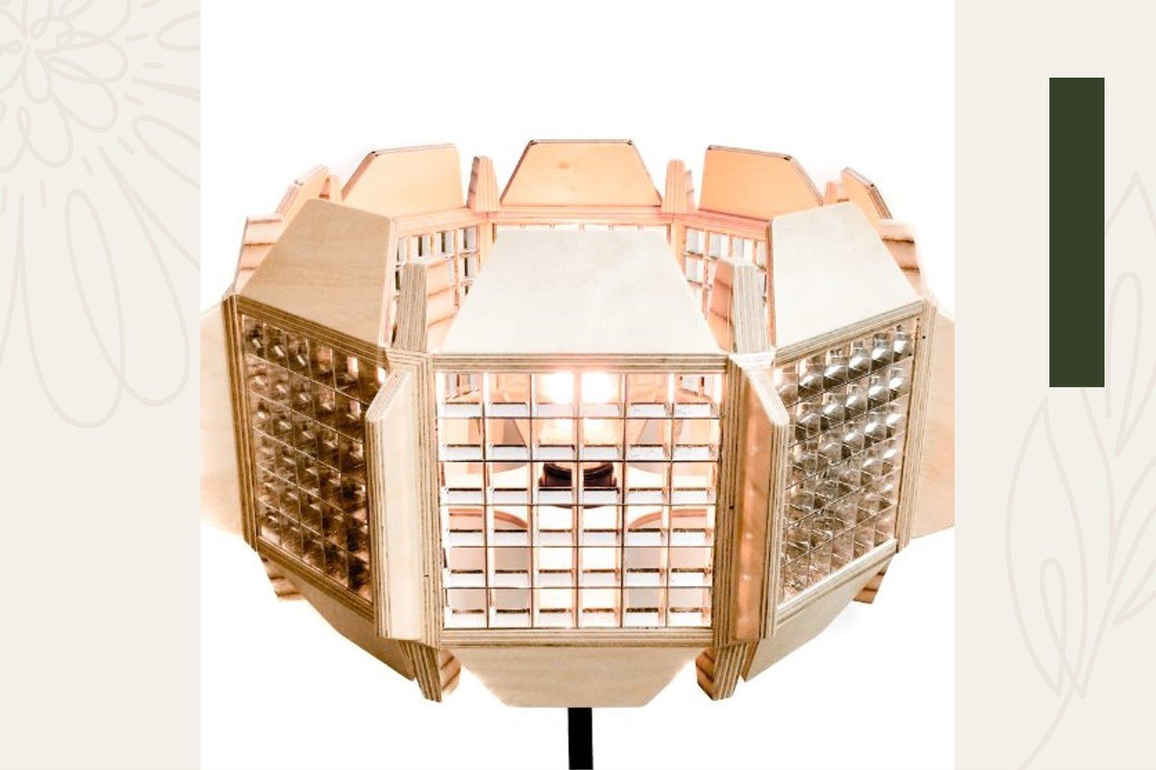 Close-up of a geometric wooden lantern with multiple sides, including glass blocks and wooden panels, illuminated from inside.