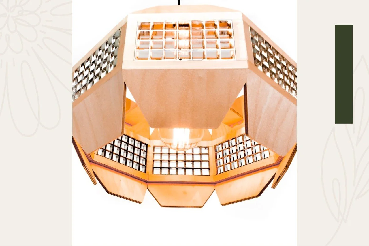 A geometric wooden ceiling light fixture with a central light bulb, surrounded by square glass panels and triangular wooden accents.