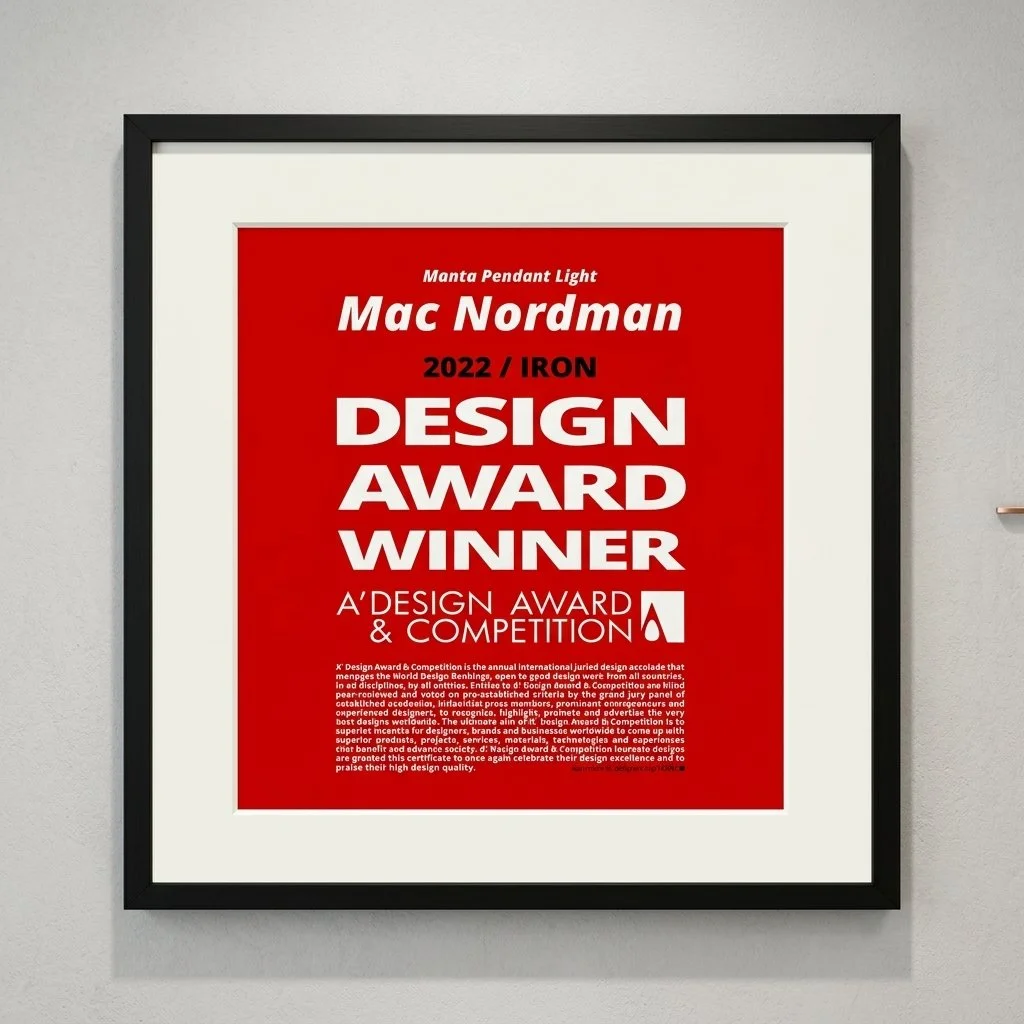Framed award certificate with a red background, recognizing Mac Nordman as the 2022 Iron Design Award Winner at the A'Design Award & Competition.