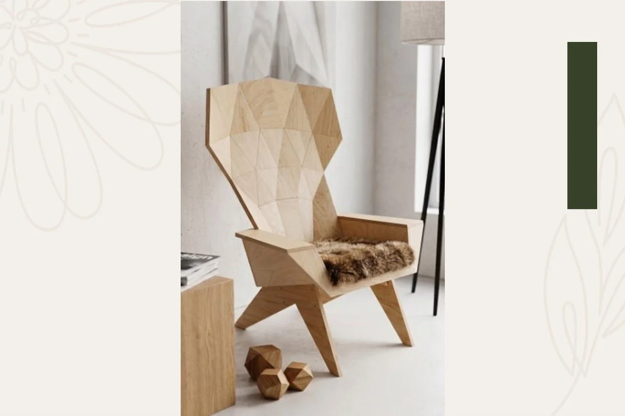 A modern wooden chair with a geometric, faceted backrest and a fur cushion on the seat, positioned in a well-lit room with a side table, a lamp, and three small wooden geometric stools nearby.