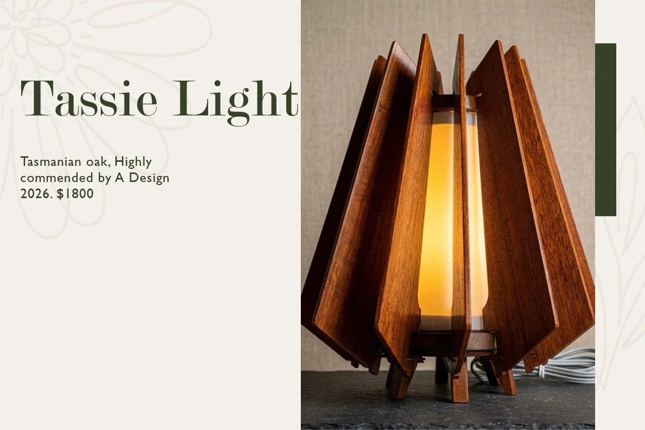 A modern table lamp made of Tasmanian oak with a wooden frame and a light-colored shade, designed by A Design, priced at $1800.