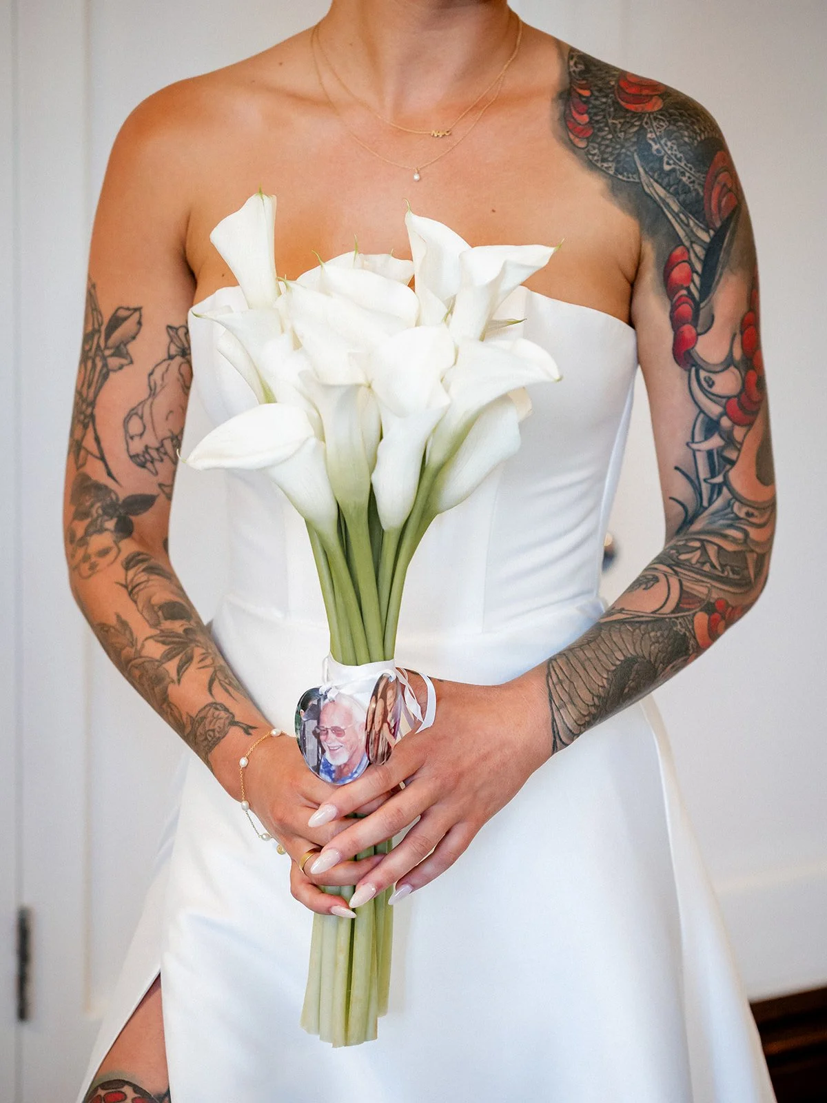 Cherry's bridal bouquet of white calla lilies with memorial charm — Jimbour House wedding by Sean Reefman Photography
