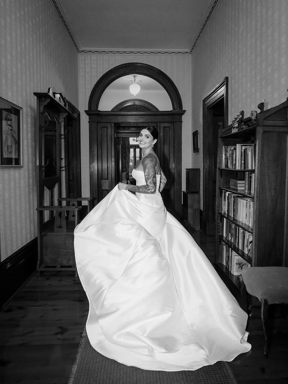 Cherry the bride in black and white swirling her dress in the hallway of Jimbour House — Sean Reefman Photography