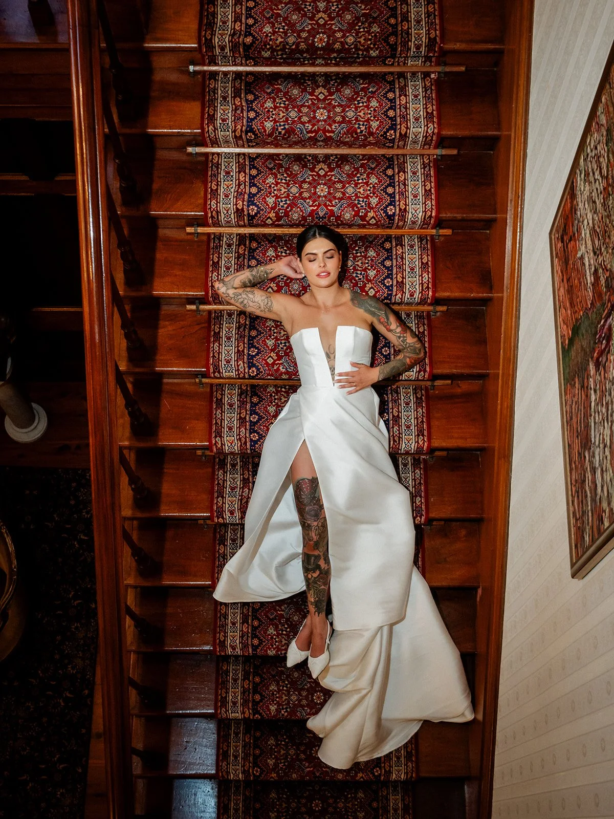 Cherry the bride lying on the grand staircase of Jimbour House overhead editorial portrait — Sean Reefman Photography