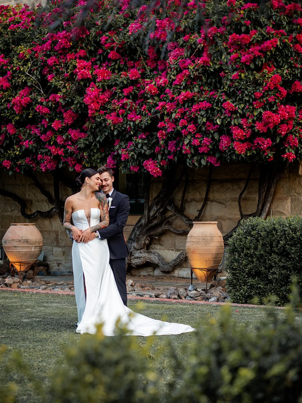 Cherry and Nick couple portrait in the gardens of Jimbour House with bougainvillea backdrop — Sean Reefman Photography