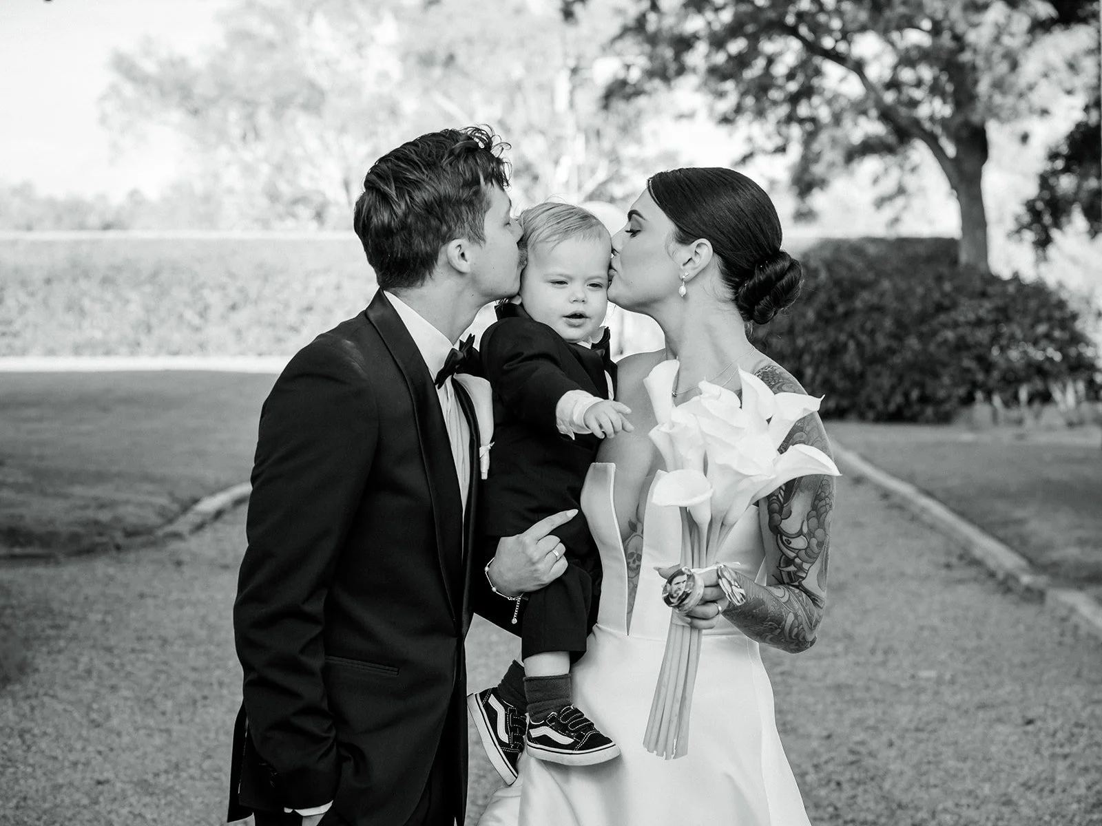 Black and white family portrait of Cherry, Nick and baby kissing their son — Jimbour House wedding by Sean Reefman Photography