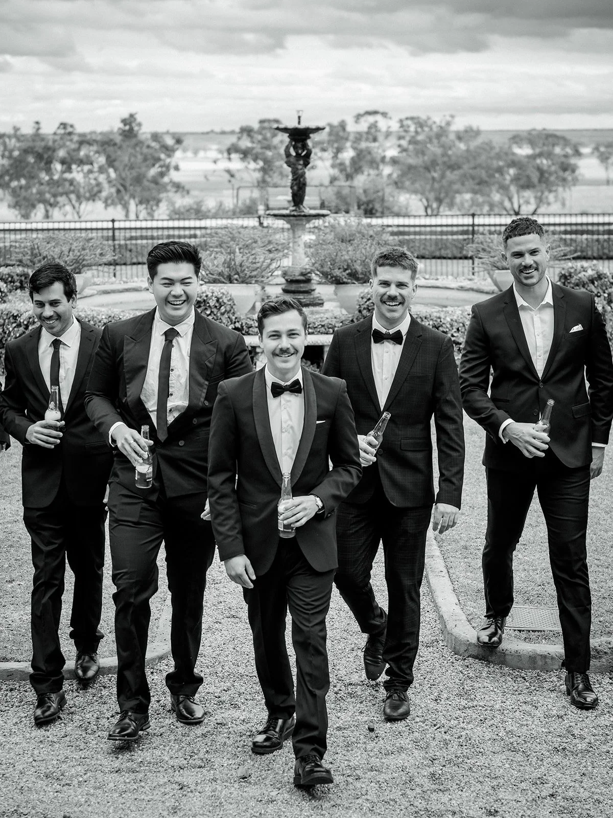 Groomsmen group portrait walking in black and white at Jimbour House fountain gardens — Sean Reefman Photography