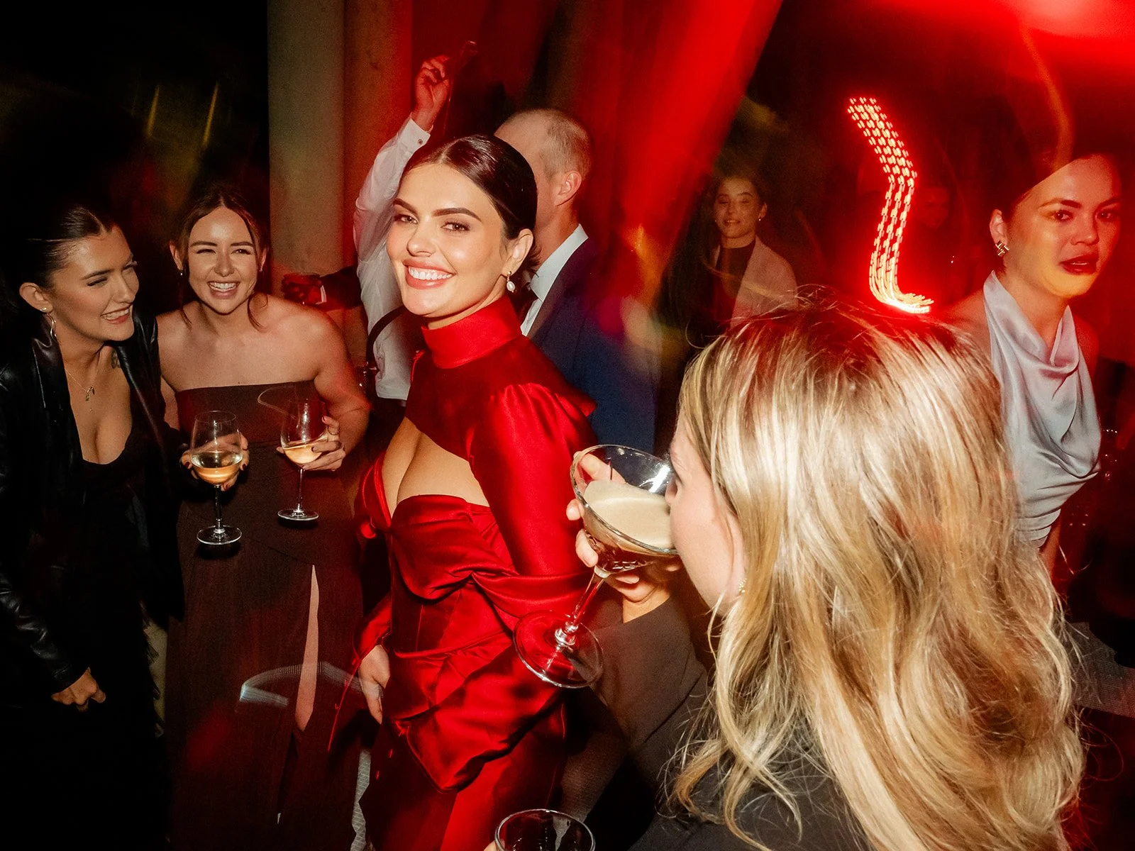 Cherry in red reception dress dancing and laughing with guests at Jimbour House reception — Sean Reefman Photography
