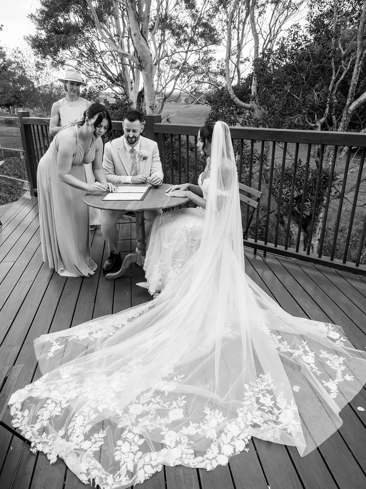 Chloe's dress and veil detail at the signing table in black and white — Sean Reefman Photography