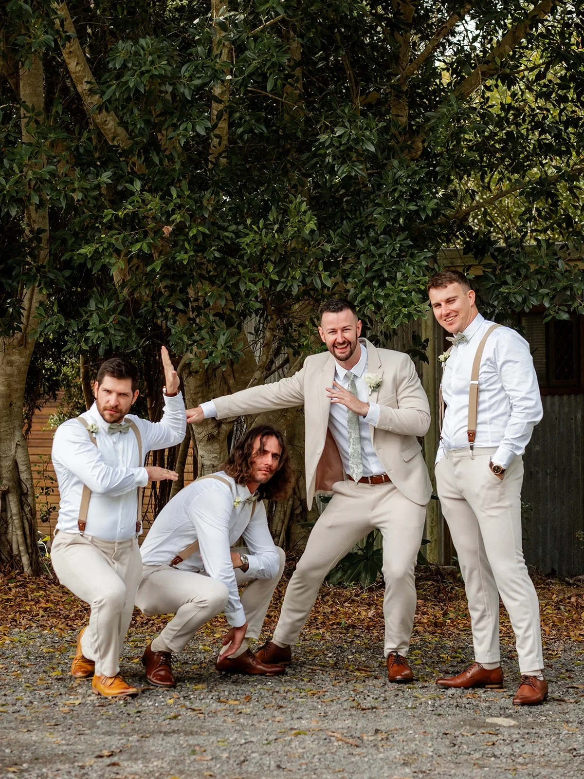 Groom and groomsmen fooling around for a playful group portrait outdoors — Sean Reefman Photography