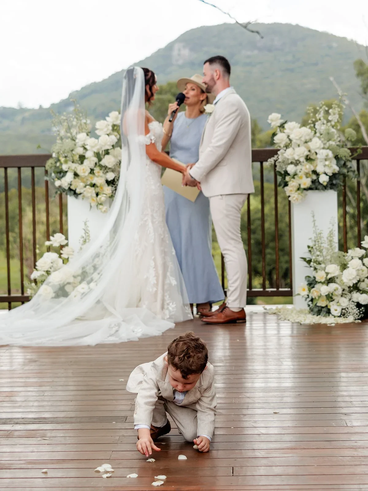 Chloe and James share their first kiss under the floral arch — Sean Reefman Photography