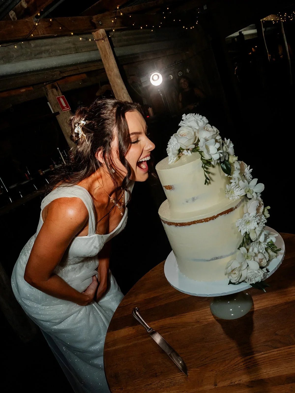 Chloe and James laughing while cutting their wedding cake — Sean Reefman Photography