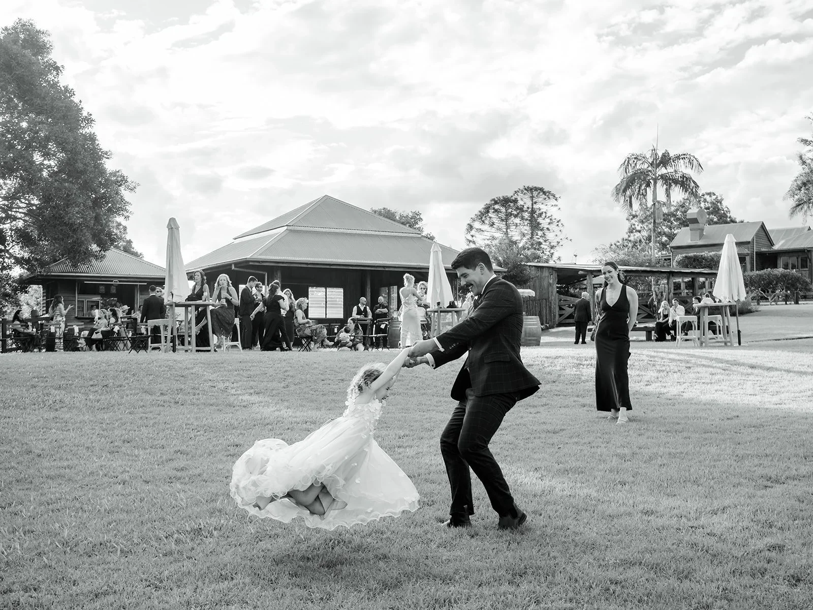 Chloe and James walking through cheering guests after the ceremony in black and white — Sean Reefman Photography