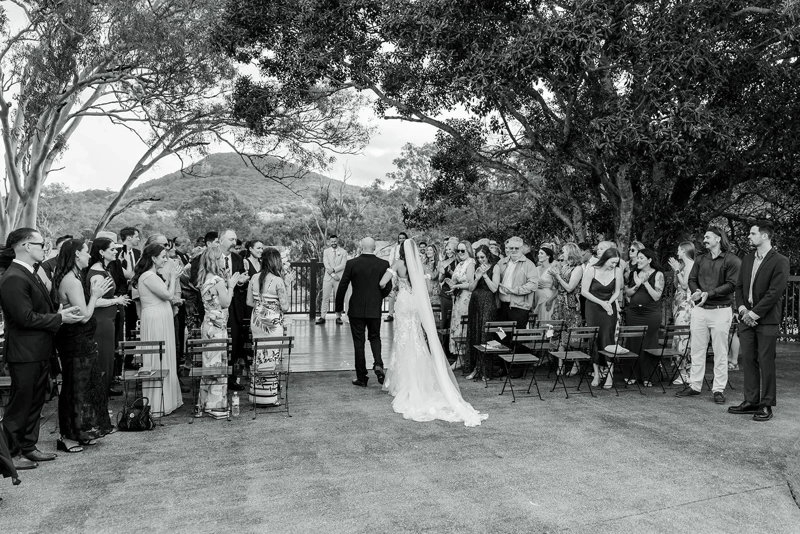 Wide black and white view of the ceremony aisle and seated guests — Sean Reefman Photography