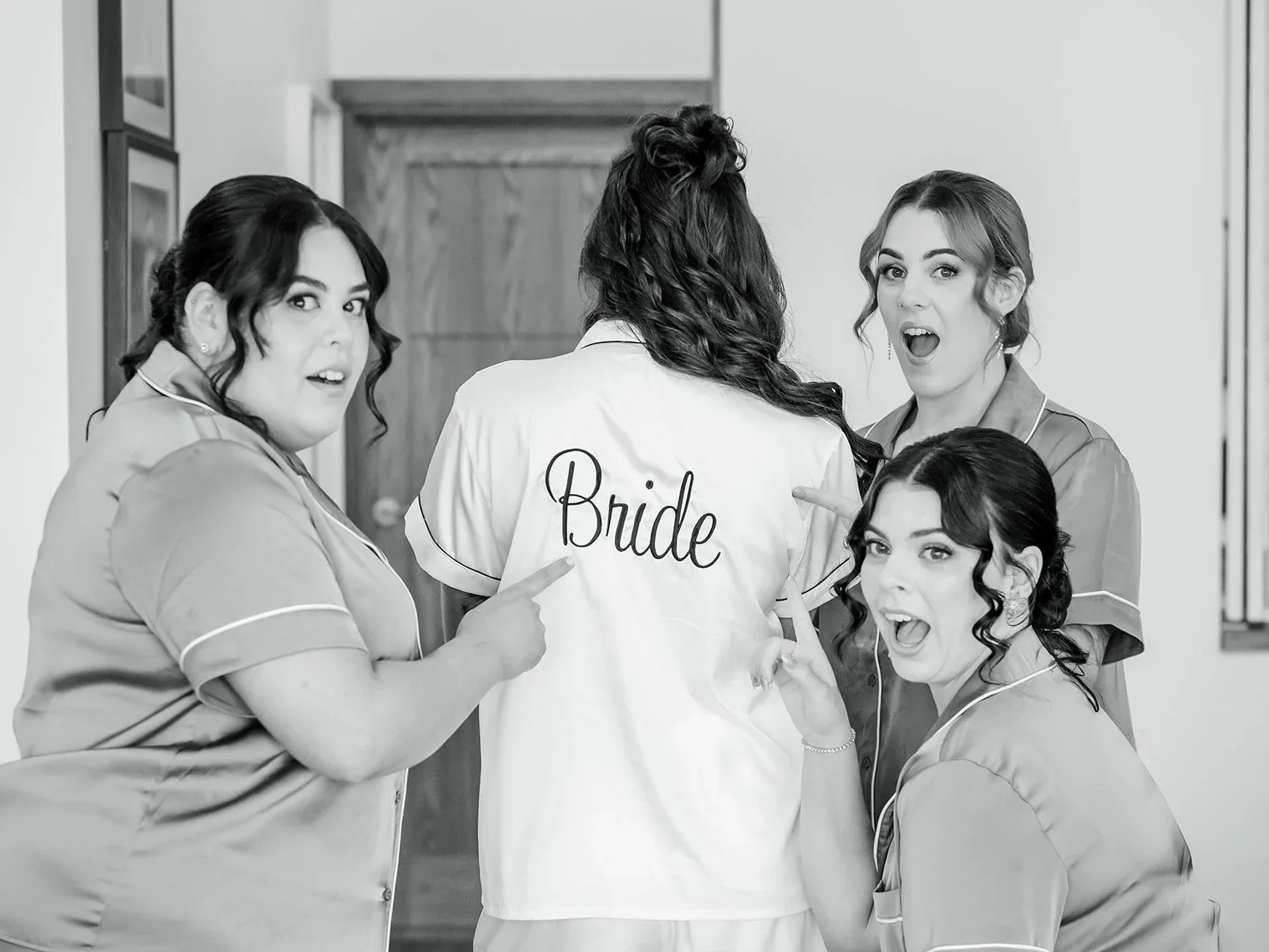 Bridesmaids laughing together while getting ready in black and white — Sean Reefman Photography
