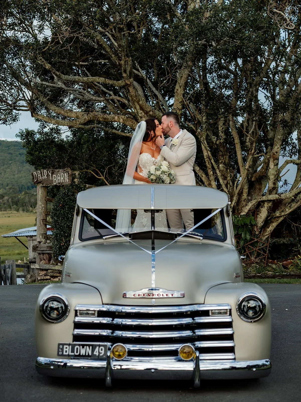 Chloe and James posing on the back of a vintage truck — Sean Reefman Photography